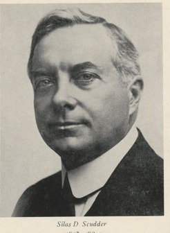 A person in a suit and tie Description automatically generated